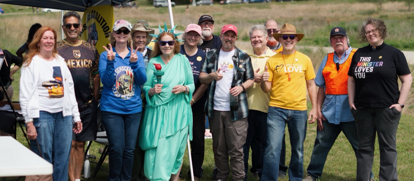 The Justice Coalition team gathered at the No Kings 3 rally, including a member dressed as the Statue of Liberty.